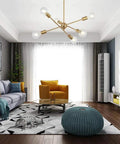 Modern Sputnik Chandelier With 6 Lights In Brushed Brass hanging in a stylish living room, mid century pendant lighting.