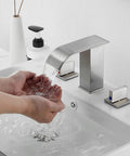 Hands under Brushed Nickel Widespread Bathroom Faucet With 3 Holes And 2 Handles Dope Modern Waterfall Sink Faucet