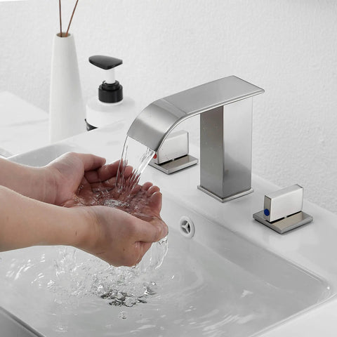 Hands under Brushed Nickel Widespread Bathroom Faucet With 3 Holes And 2 Handles Dope Modern Waterfall Sink Faucet