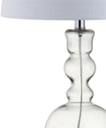 Close-up of curved clear glass base of modern bedside lamp with white linen shade, part of Clear Glass Table Lamp Set of 2 for Living Room and Bedroom Decor, Modern Bedside Lamps With White Linen Shades, LED Bulbs Included, 28.5-Inch Tall, Sleek Home Lighting for Any Space, ETL Listed UL Certified.