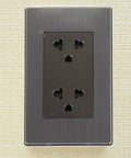Heavy-Duty 6-Hole Circular Wall Outlet Socket Cover In Rust-Free Stainless Steel mounted on light textured wall.