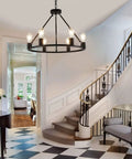 Industrial Black Wagon Wheel Chandelier With Six Candle Style Lights in elegant hallway, 23.6 Inch Metal Round Light.