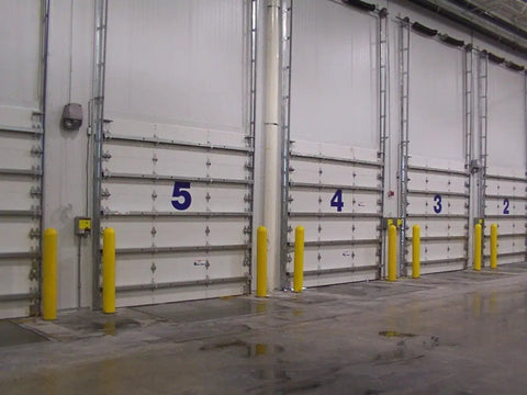 Slide On Yellow Bollard Post Cover For Warehouses Made From Durable Low Density Polyethylene Thermoplastic protecting warehouse doors.
