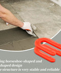 Red 50 Pack U Shaped Tile Spacers One Eighth Inch For Leveling next to hand laying tile with mortar in DIY project