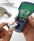 Person inserting 9V alkaline battery into a meter, showcasing reliable 9 volt battery pack for home use