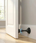 Heavy Duty Matte Black Magnetic Door Stopper 2 Pack Multi Angle Wall Guard Stops slamming doors with non-slip base attached to open door.