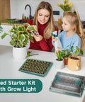 Woman and child planting with Two Pack Seed Starter Tray With Grow Light, 80 Cell Seed Starting Kit visible on table