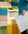 Person assembling 2 Pack Telescoping Beehive Cover Kit With Inner Covers And Feeding Jar Lids For 10 Frame Beehives