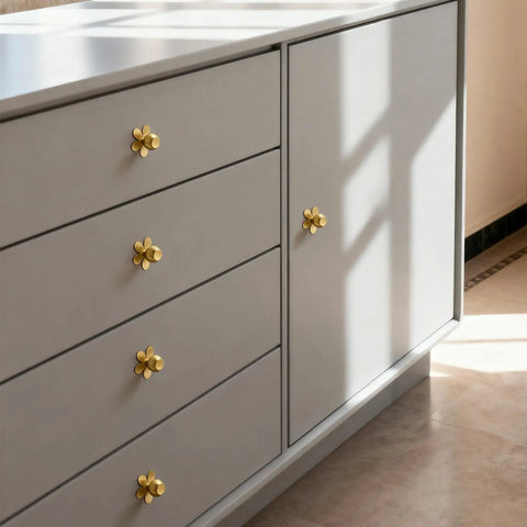Real Deal Solid Brass Cabinet Knobs Slick Flower Backplate Brushed Gold Finish on grey dresser drawer fronts