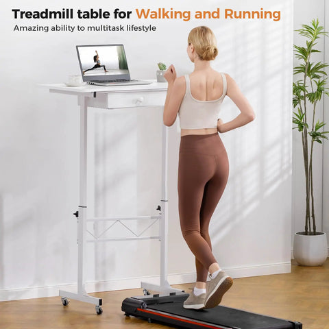 Person using Compact Adjustable Standing Desk On Wheels For Home Office with laptop, next to treadmill in bright room