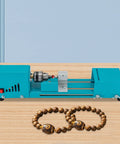 Mini Wood Lathe Machine With A Hella Strong 96W Copper Motor Spinning At 9000 Rpm for crafting beads on a wooden surface.