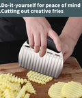 Large crinkle cutter knife with rubber handle, stainless steel blade slicing crinkle-cut potatoes on a wooden board