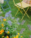 Two-Piece Concrete Footprint Stepping Stone Template Kit for Walkways, Garden, Yard and Patio Decor installed among flowers