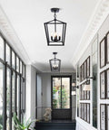 Farmhouse Lantern Pendant Light for Kitchen Island and Dining Room, 12 Inch Black Openwork Cage Chandelier in a hallway setting
