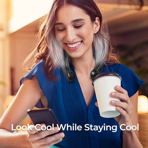 Woman using Portable Neck Air Conditioner Fan 2026 Upgrade with Three Cooling Plates while holding a coffee cup, indoors.