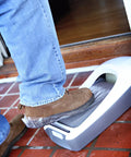 Applying shoe cover on EZ Floor Guard Starter Kit With Heavy Duty 2.45 Mil Film, Holds 187 Pairs Of Disposable Shoe Covers, White.