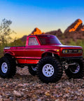 Red 1/10 Scale Rock Crawler With High Torque 4WD Portal Axles on rocky terrain at sunset