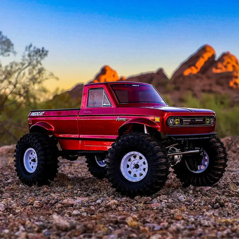 Red 1/10 Scale Rock Crawler With High Torque 4WD Portal Axles on rocky terrain at sunset