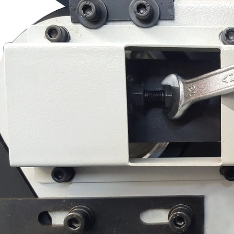 Close-up of the interior mechanism of a Rugged 4x48 Inch Industrial Belt Grinder With 76 Fps, showing the motor and adjustment tools.