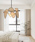 Bedroom scene with fan shaped pendant light with woven shade and silver finish, cozy ambiance.
