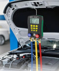 BELEY automotive HVAC digital manifold gauge with blue, yellow and red hoses, front view over car engine bay