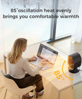 Indoor Space Heater 1500W Ceramic PTC With Thermostat And 24Hour Timer, Instant Two Second Heat on desk beside woman working