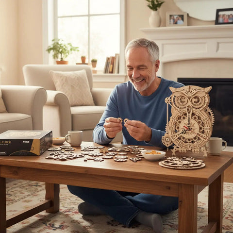 Owl 3D Wooden Puzzle Clock Kit For Adults And Kids Desk Clock Model For Home Decor With Mechanical Quartz Movement Silent Timekeeping Built In Timer No Glue Needed Battery Powered AA Not Included An Awesome Gift For Birthday Or Christmas. man assembling wooden owl desk clock on table