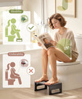 Woman using 7 Inch Folding Toilet Stool for Adults Bamboo Rustic Brown, demonstrating bathroom comfort with anti-slip strip.