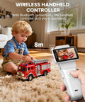 Child playing with fire truck toy controlled by a wireless handheld controller with Bluetooth connectivity indoors.