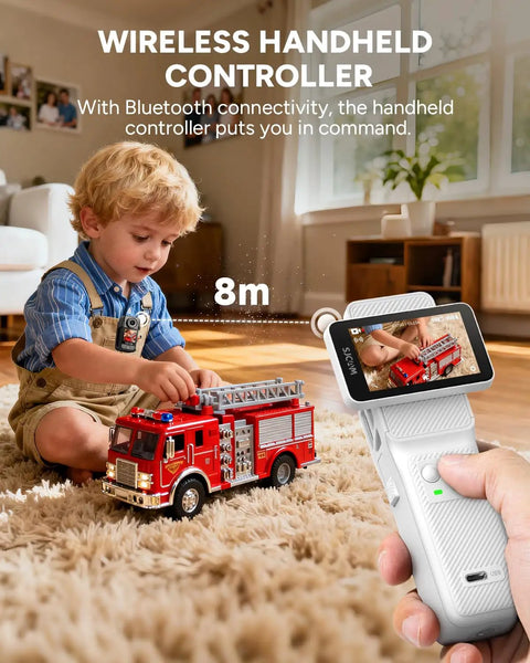 Child playing with fire truck toy controlled by a wireless handheld controller with Bluetooth connectivity indoors.