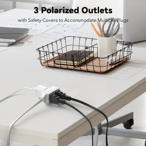 6 Ft Indoor Extension Cord With 3 Outlets Polarized 2 Prong Plug 2 Pack White Built For Home Office Lamps Fans Holiday Lights And Everyday Power Needs, shown plugged into a desk outlet.