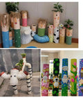 Decorative display of painted four heavy duty white schedule 40 PVC pipes 1.5 inch diameter by 17 inch length used as planters.