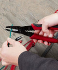 Person using 8 Inch Multi Tool Wire Stripper Crimper And Bolt Cutter For Electricians Long Nose Pliers on a green wire.