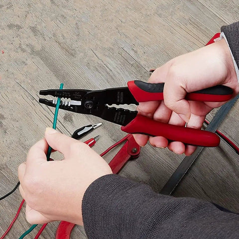 Person using 8 Inch Multi Tool Wire Stripper Crimper And Bolt Cutter For Electricians Long Nose Pliers on a green wire.