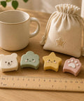 Silicone Corner Guards 16 Pack Soft Edge Protectors For Furniture In Paw Cloud Bear And Star Shapes Kid Safe Nursery Home Edge Cushions on table with ruler and drawstring bag.