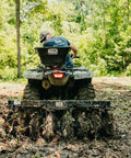 Tow Behind Notched Disc Harrow Attachment for ATV UTV 4 Ft Wide With 2 In Towball Hitch 14 In Concave Discs in use on muddy trail