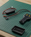 Heavy Duty Electric Rc Winch For 1/10 Scale Crawler Cars With Dual Control And Sturdy Metal Build showing remote controller and connection wires.