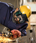 Job Site Tough Flip Up Welding Safety Glasses With Vented Anti Fog Shell Double Layer Shatterproof Lenses For Stick Mig Argon Cuts And Everyday Shop Grinds 2 Pack worn by worker with yellow helmet.