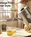 Gooseneck Electric Kettle With Thermometer, 1 Liter, 304 Stainless Steel, Auto Shut Off, 1200W For Barista-Grade Pour Over Coffee And Tea At Home, Office, Or Cafe, Chrome Finish For Everyday Use pouring tea into glass cup.