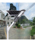 Heavy Duty 120W Solar Street Light With Motion Sensor Tough Aluminum Housing mounted on a pole illuminating a pathway.