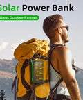 Hiker with a yellow backpack featuring Beast 49800mAh Solar Power Bank With Wireless Charging 22W Fast Charge attached outdoors.
