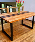 Wooden table with 28 inch high black metal table legs, set of 2, modern industrial design in a dining room setting.