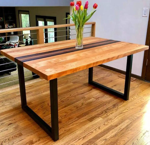Wooden table with 28 inch high black metal table legs, set of 2, modern industrial design in a dining room setting.