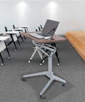 Solid As A Rock Adjustable Lectern And Podium Stand With Grease Free Casters, table with laptop in modern classroom setting.