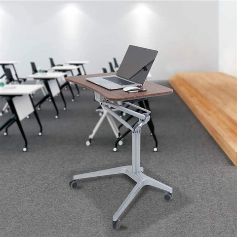 Heavy Duty Adjustable Height Lectern Podium Cart With Gliding Rubber Casters And Roomy Wood Grain Top in a classroom setting with a laptop.