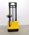 Heavy Duty Electric Thin Leg Pallet Stacker As A No Fuss Heavy Hitter With 2204 Lb Load Capacity And 130 Inch Lift Height featuring a yellow body and power steering.