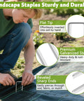 Man installing Heavy Duty 12 Inch Galvanized Landscape Staples For Weed Barriers And Lawn Projects on garden fabric