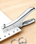 Single Hole Punch 1.9 Inch Throat 6 mm Hole Handheld Metal Punch for office use, showing metal frame and carbon steel cutter head on desk