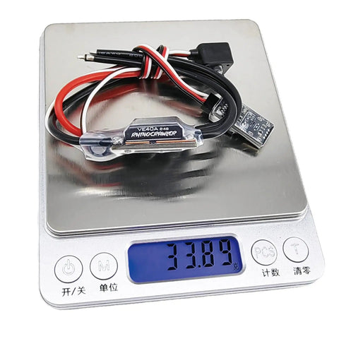 AM32 40A Crawler ESC With 5.2 To 8.2V BEC on digital scale displaying 33.89 grams