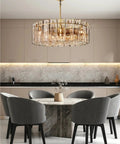 Retro American Chrome Brass Hanging Lamp Dimmable LED Pendant illuminating a modern dining area with stylish gray chairs.